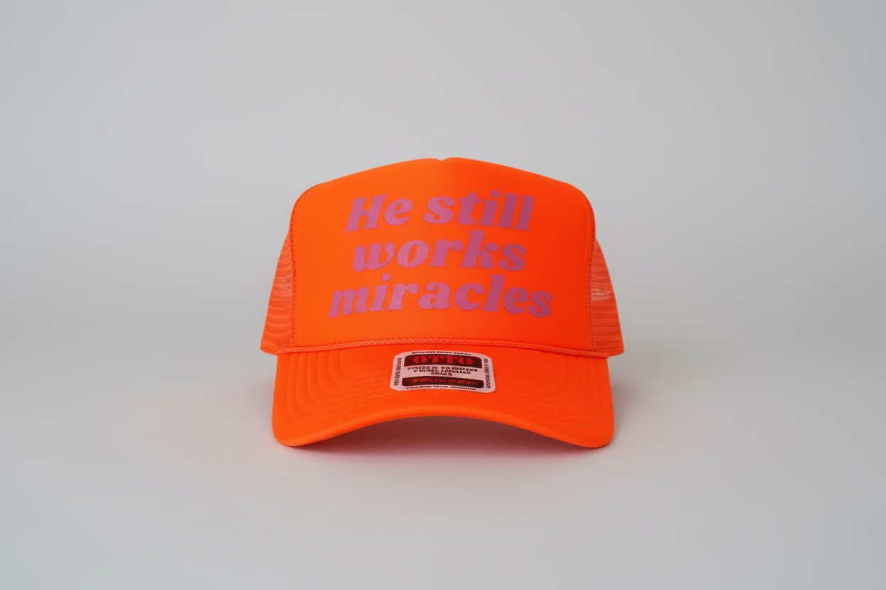 Neon Orange He Still Works Miracles Hat